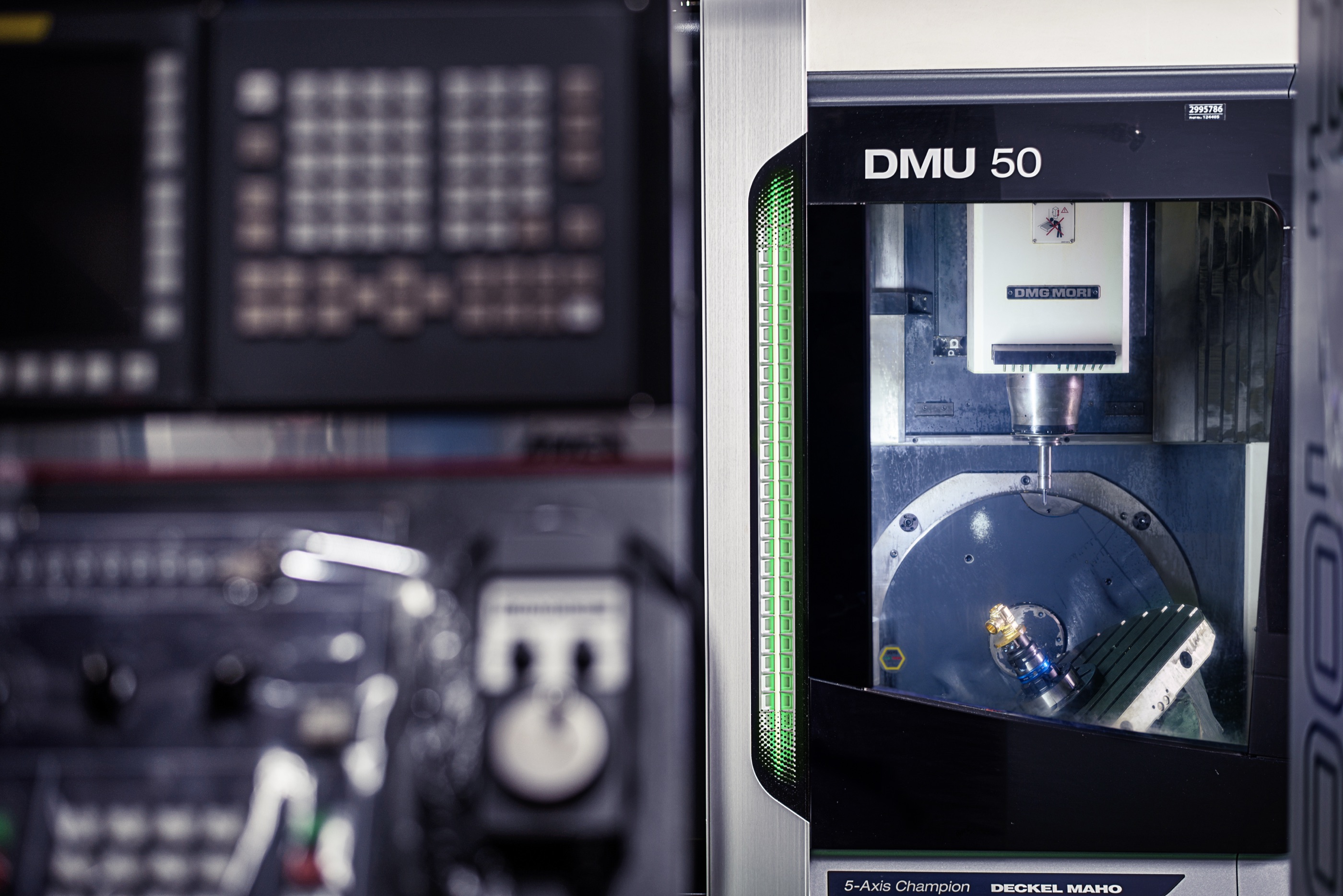 DMG MORI DMU 50 five-axis machine cutting a valve part